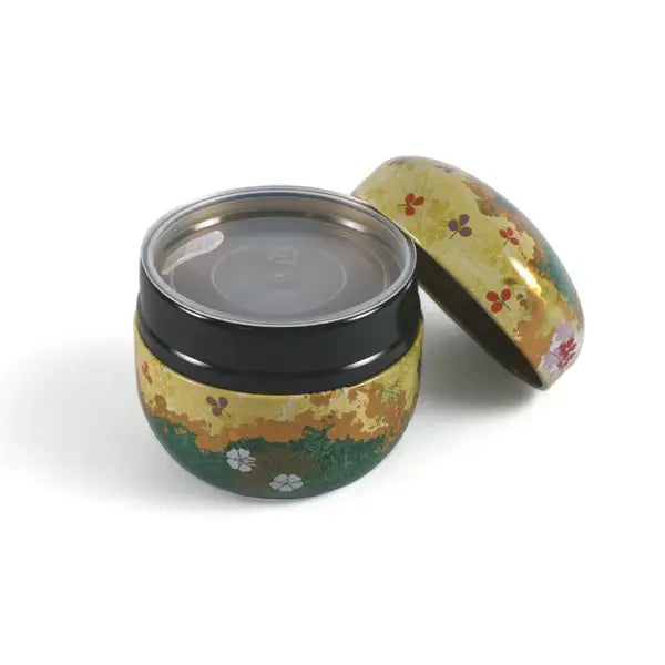 Decorative metal tin with floral design on a white background