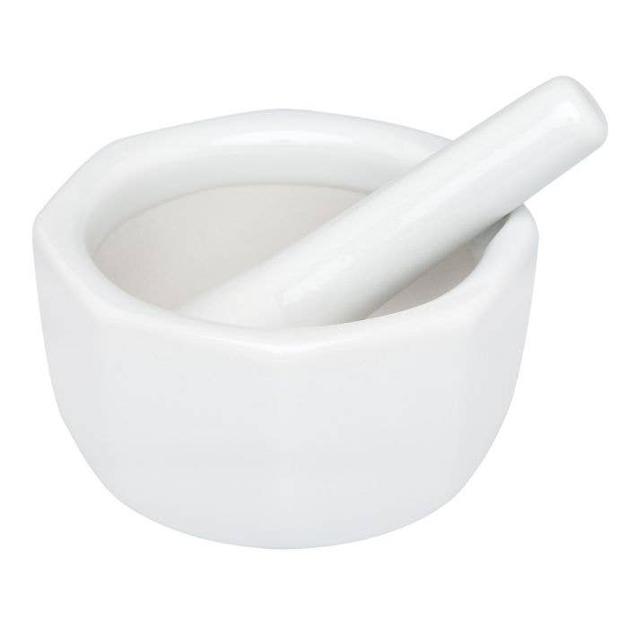 White ceramic mortar and pestle on a white background