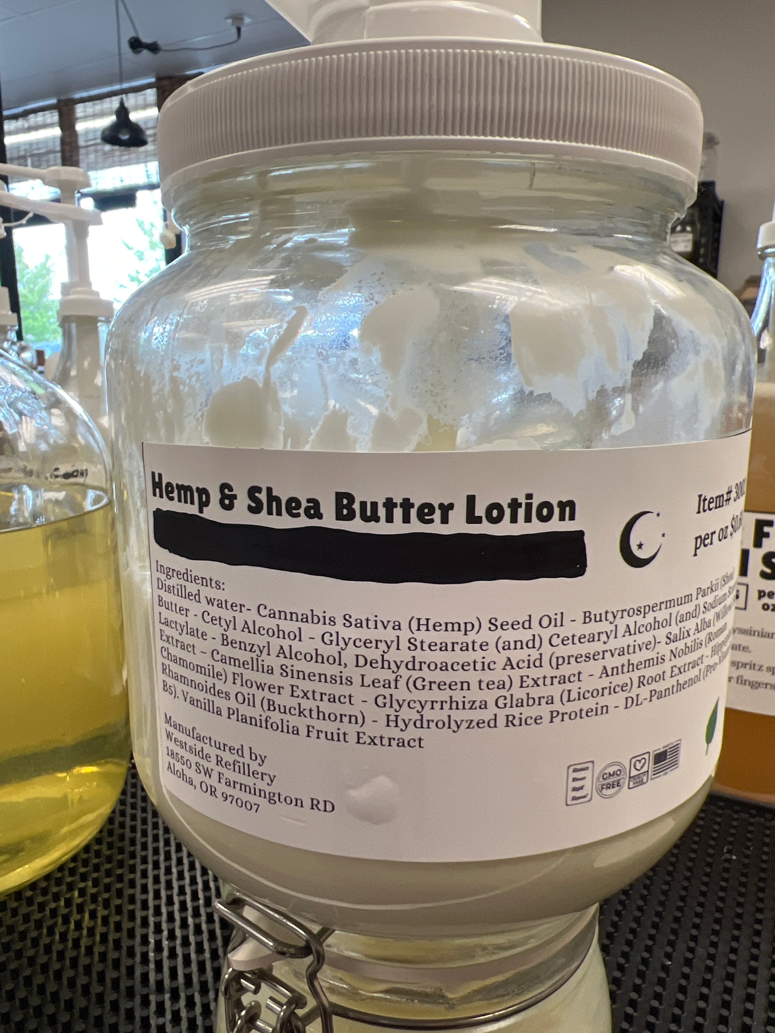 Jar of Hemp & Shea Butter Lotion with a label on a blurred background