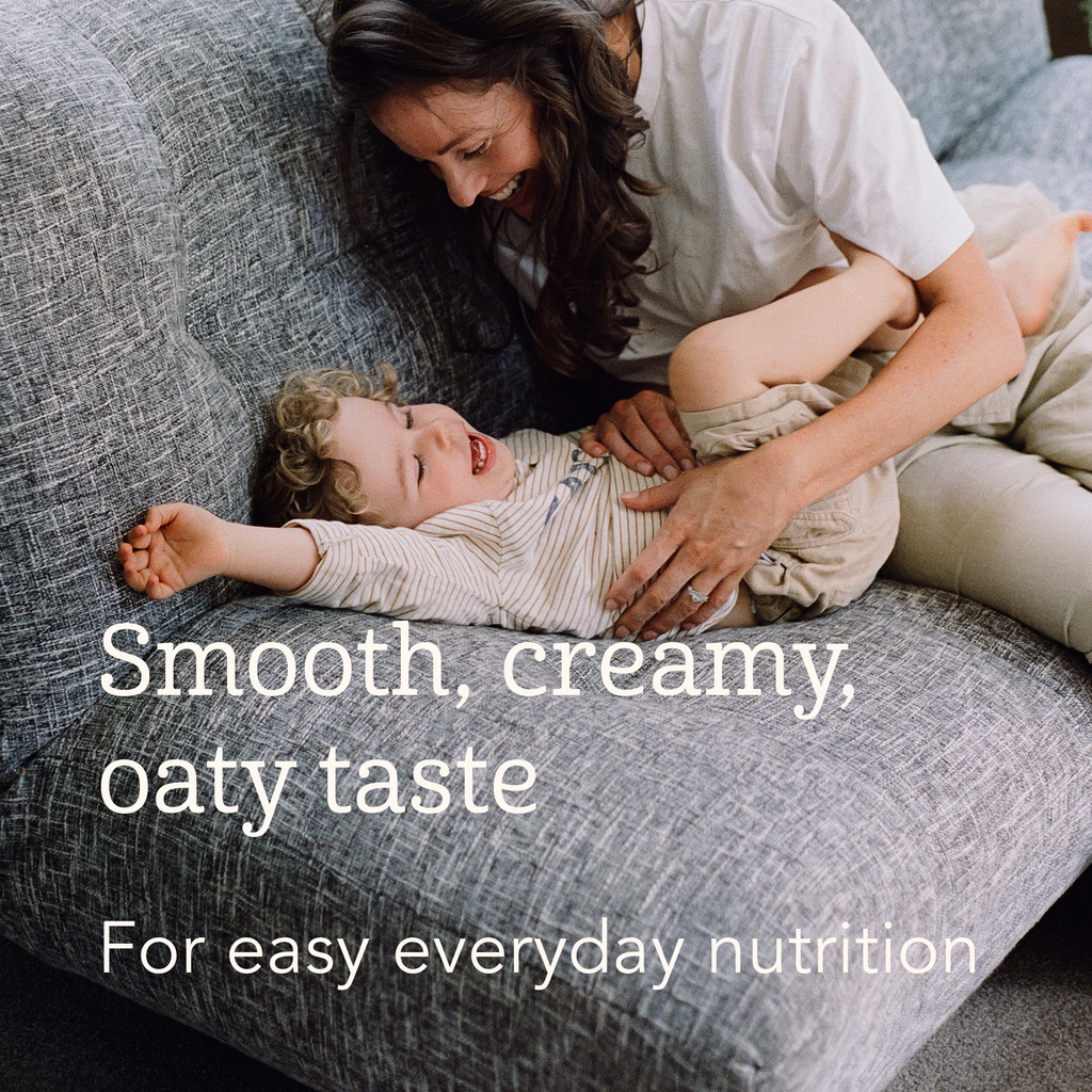 Woman holding a baby on a couch with text about smooth, creamy, oaty taste