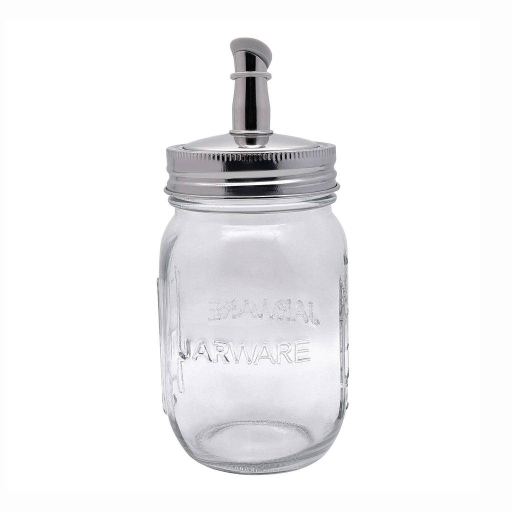 Clear glass jar with silver lid and spout on a white background