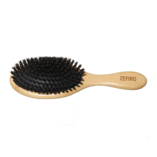 Hairbrush with black bristles and wooden handle on a white background, branded 'Zefiro'.