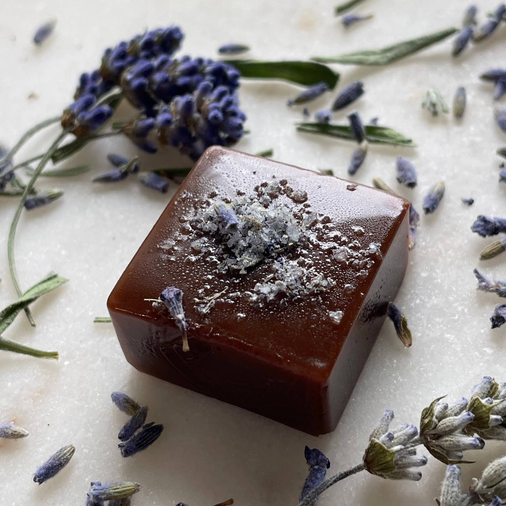 Bar of soap with lavender flowers on a light background