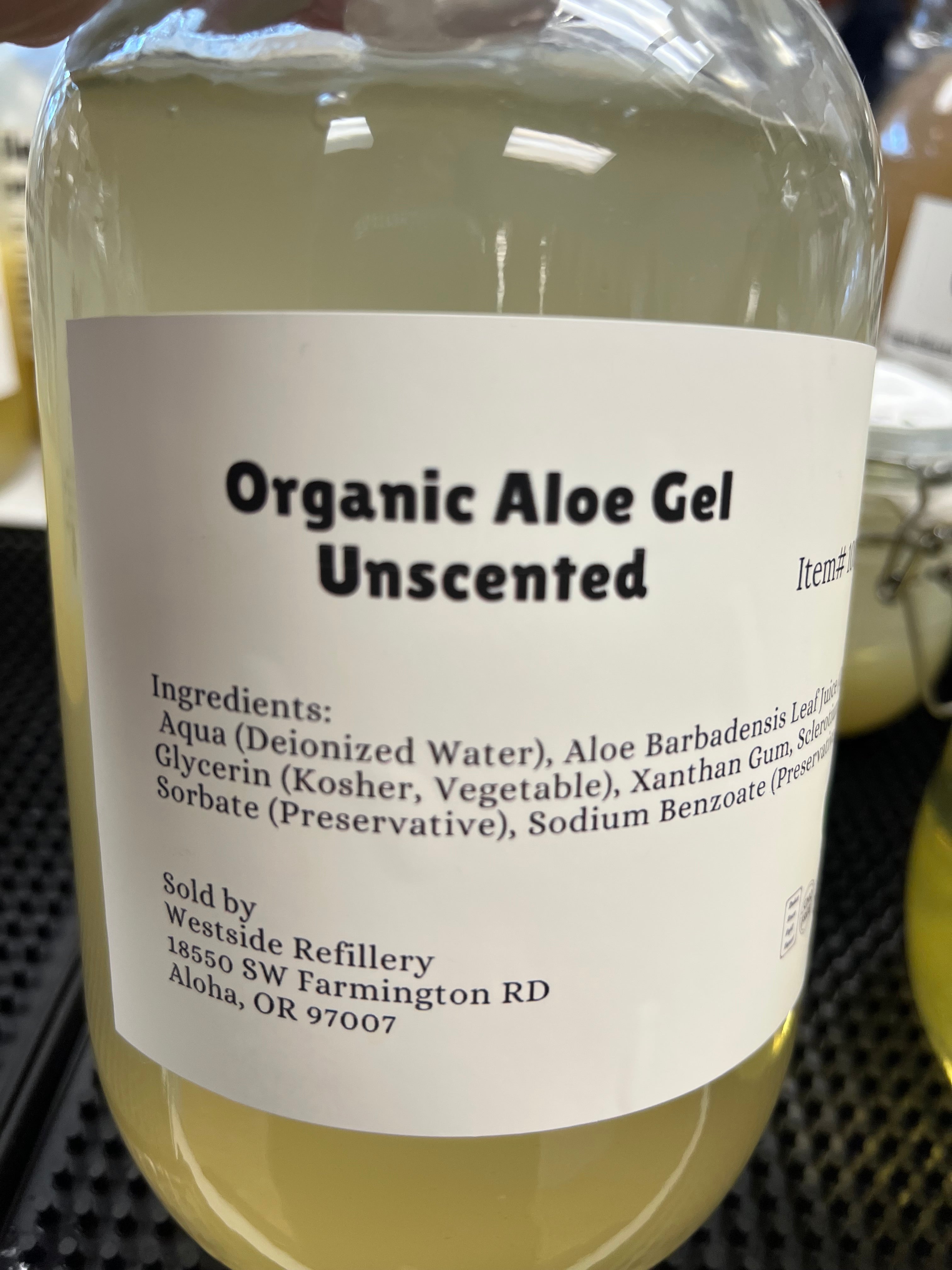 Bottle of Organic Aloe Gel with a label on a blurred background