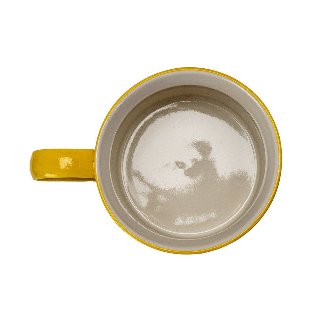 Yellow mug with a white interior on a white background