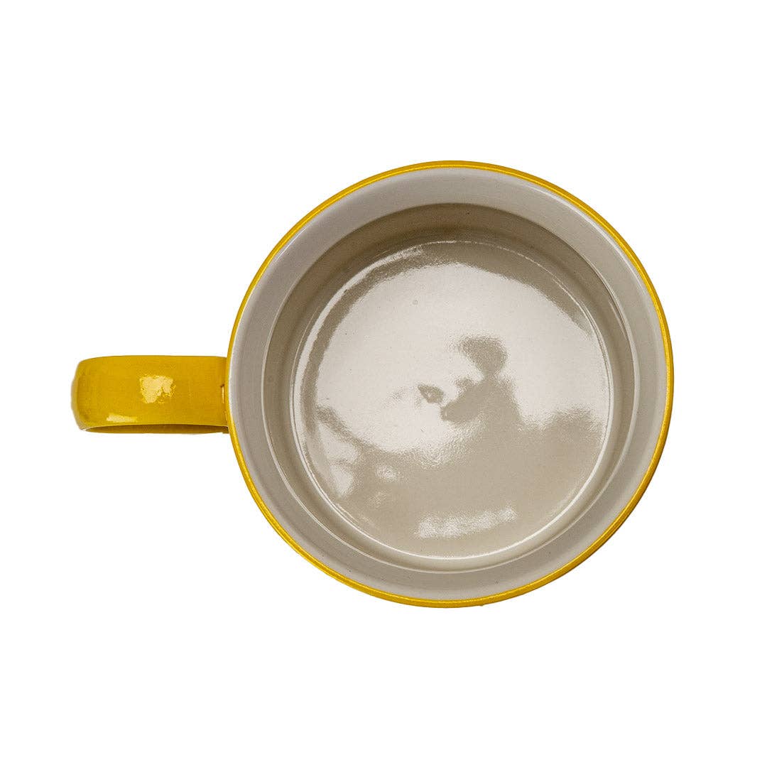 Yellow mug with a white interior on a white background