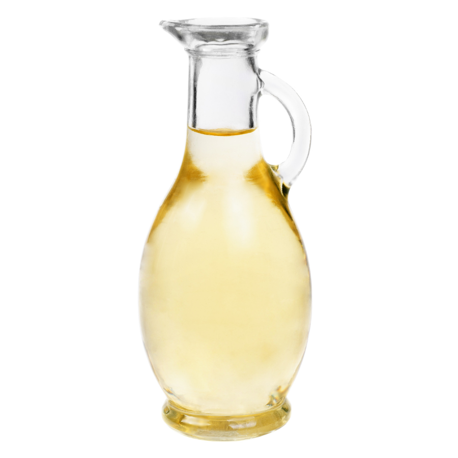 Clear glass carafe filled with rice vinegar on a white background