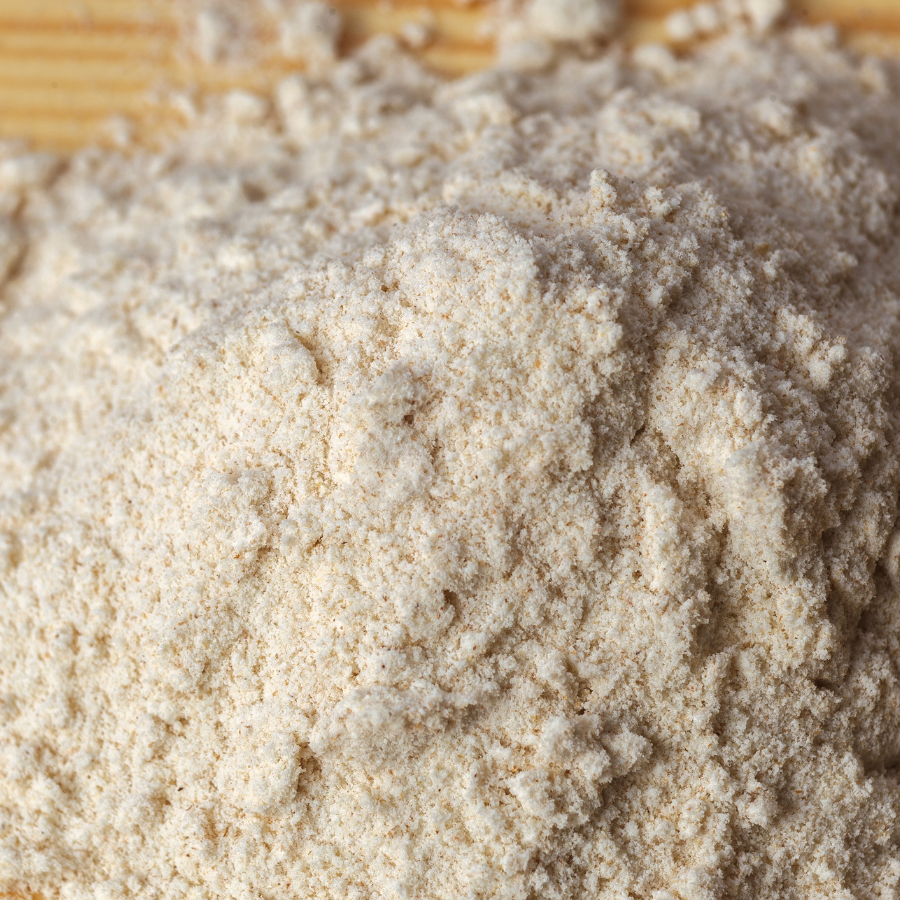 Close-up of a pile of light brown powder on a wooden surface