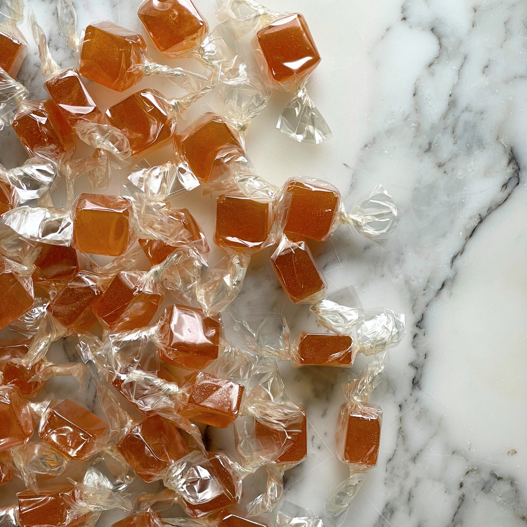 Candies in clear wrappers on a marble surface