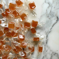 Candies in clear wrappers on a marble surface