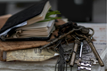 Vintage keys and open book on a textured surface