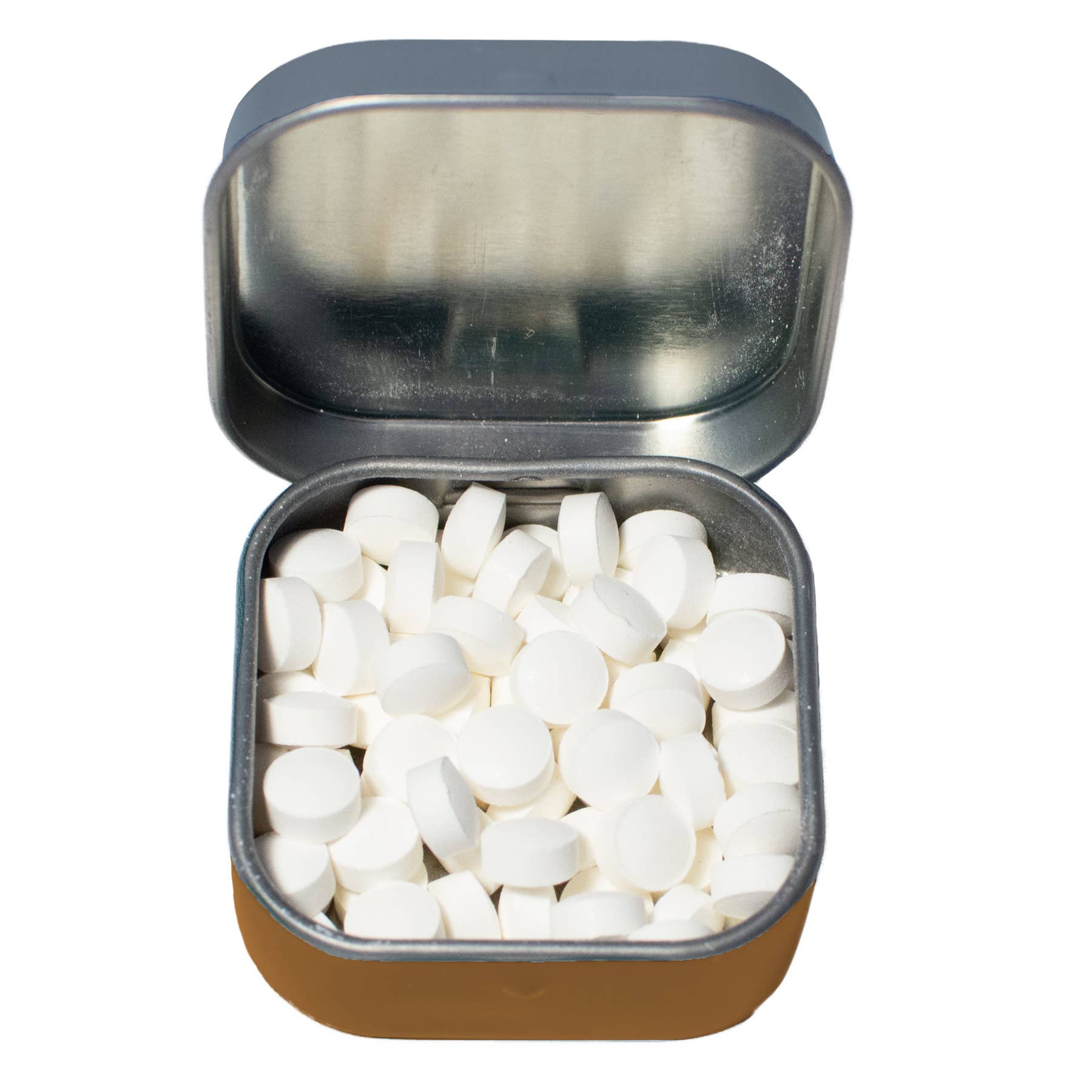 Open metal tin filled with white tablets on a white background