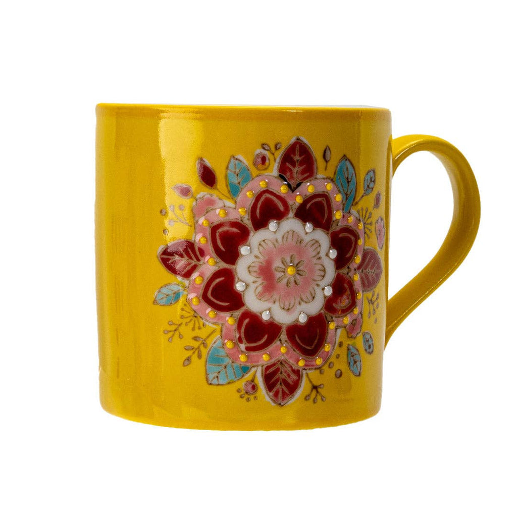 Yellow mug with a colorful floral design on a white background