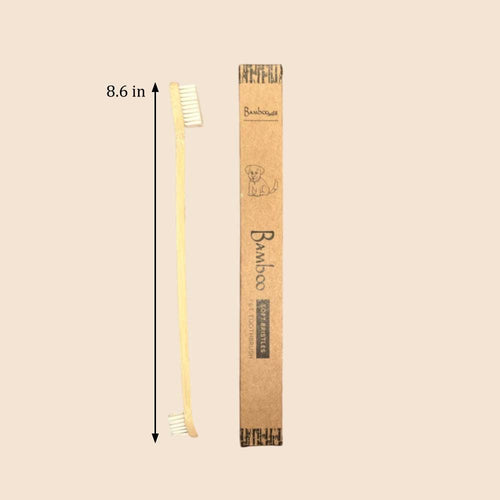 Bamboo toothbrush with packaging and measurement label on a beige background