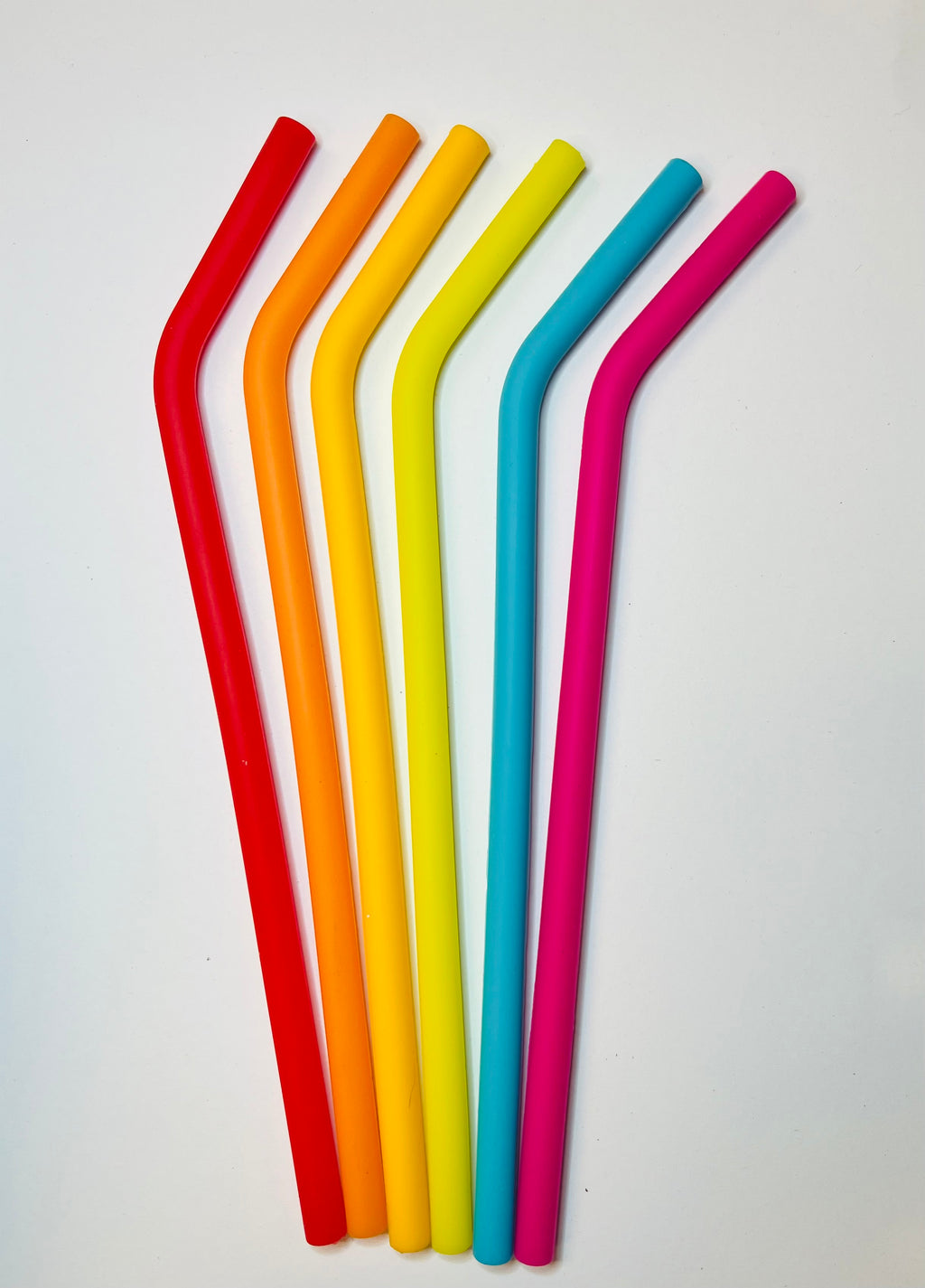 6 Silicone straws in rainbow colors with bend on a white background.