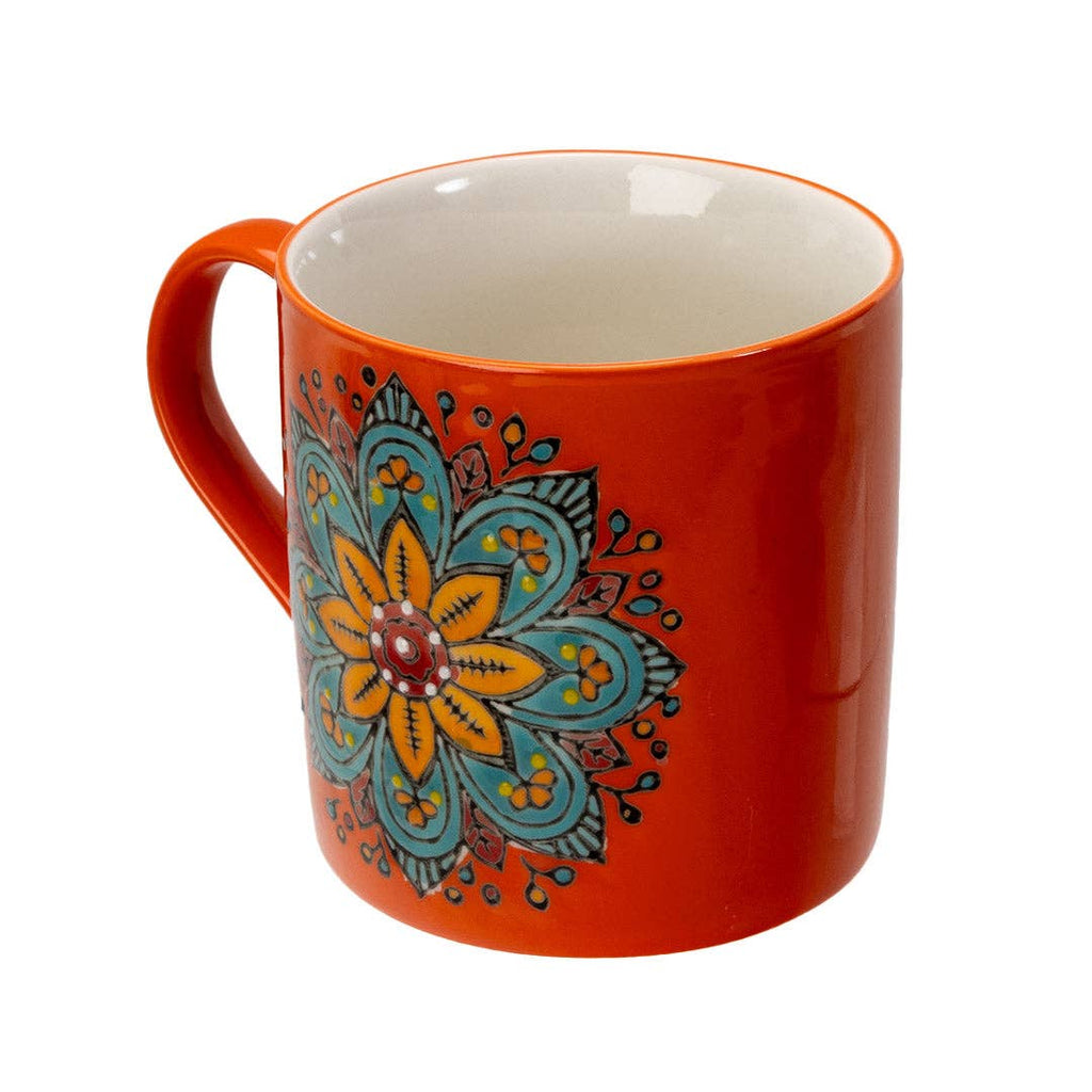 Orange mug with a colorful floral design on a white background