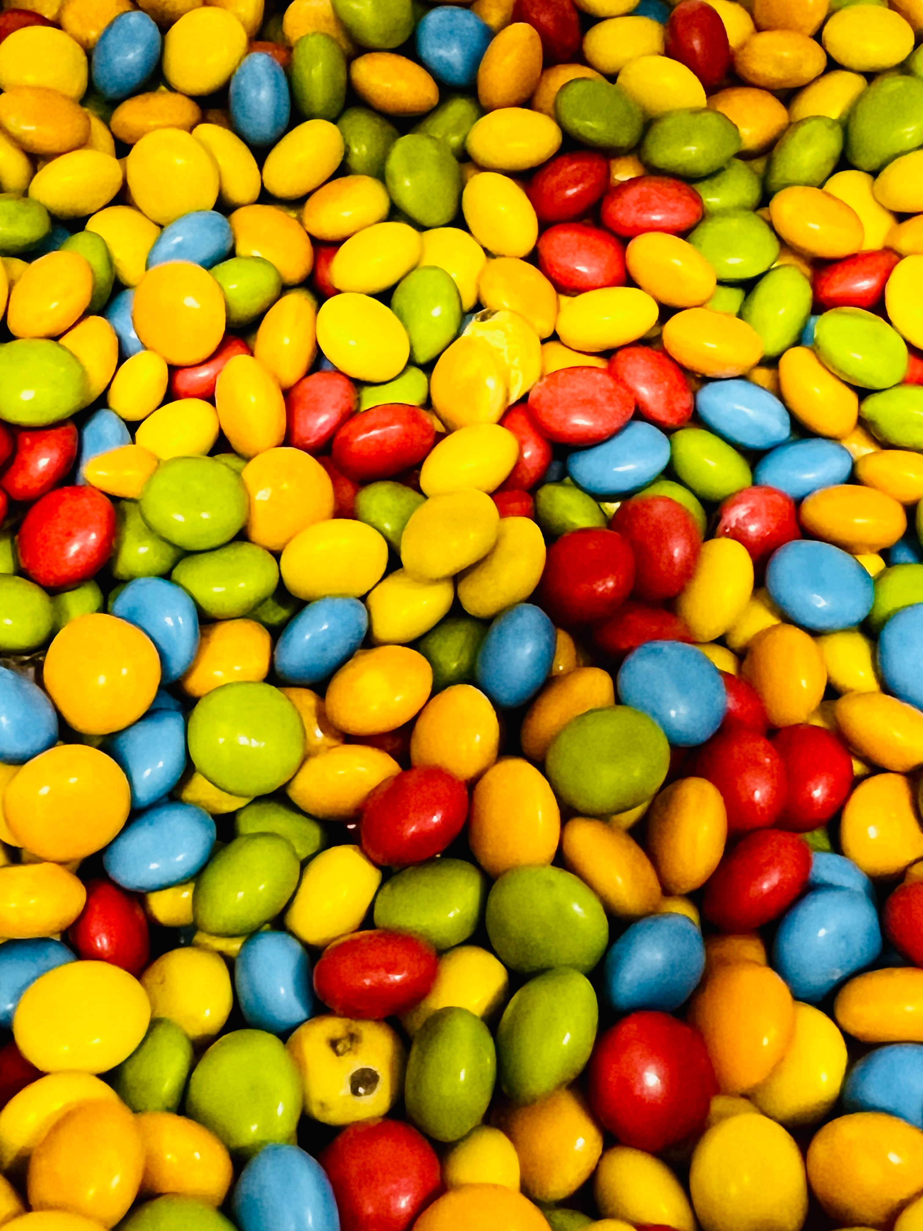 Assorted colorful candies including red, yellow, blue, green, and orange.