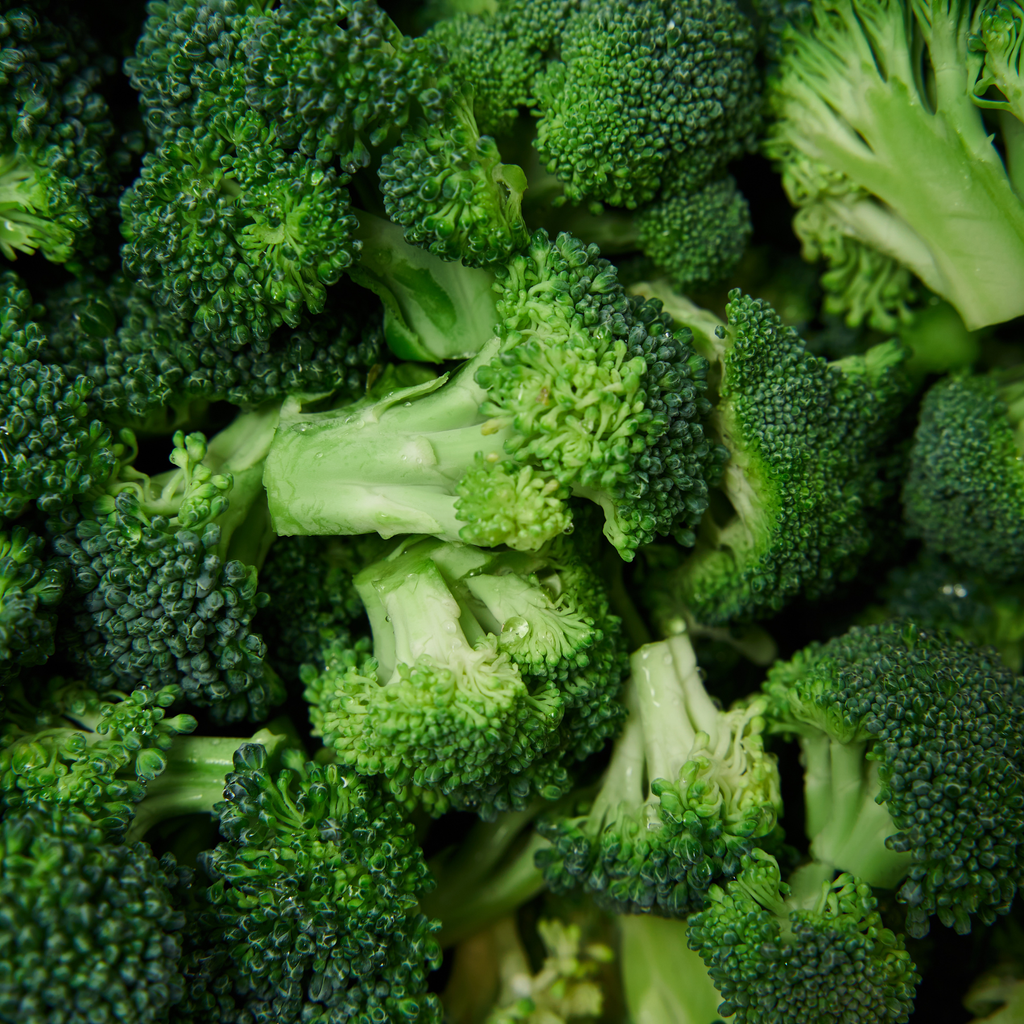 Close-up of fresh green broccoli florets and stems filling the frame.