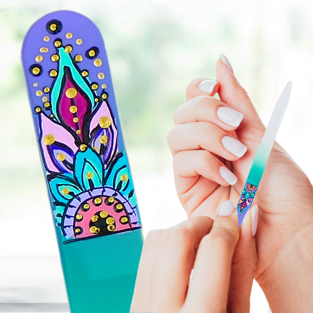 Colorful nail art design on a blue and green background with a hand holding a nail file.