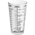 Clear measuring glass with volume markings on a white background