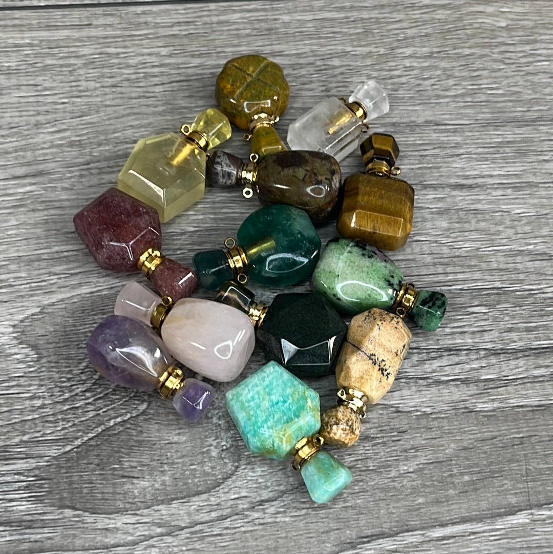 Colorful stone bottles on a wooden surface