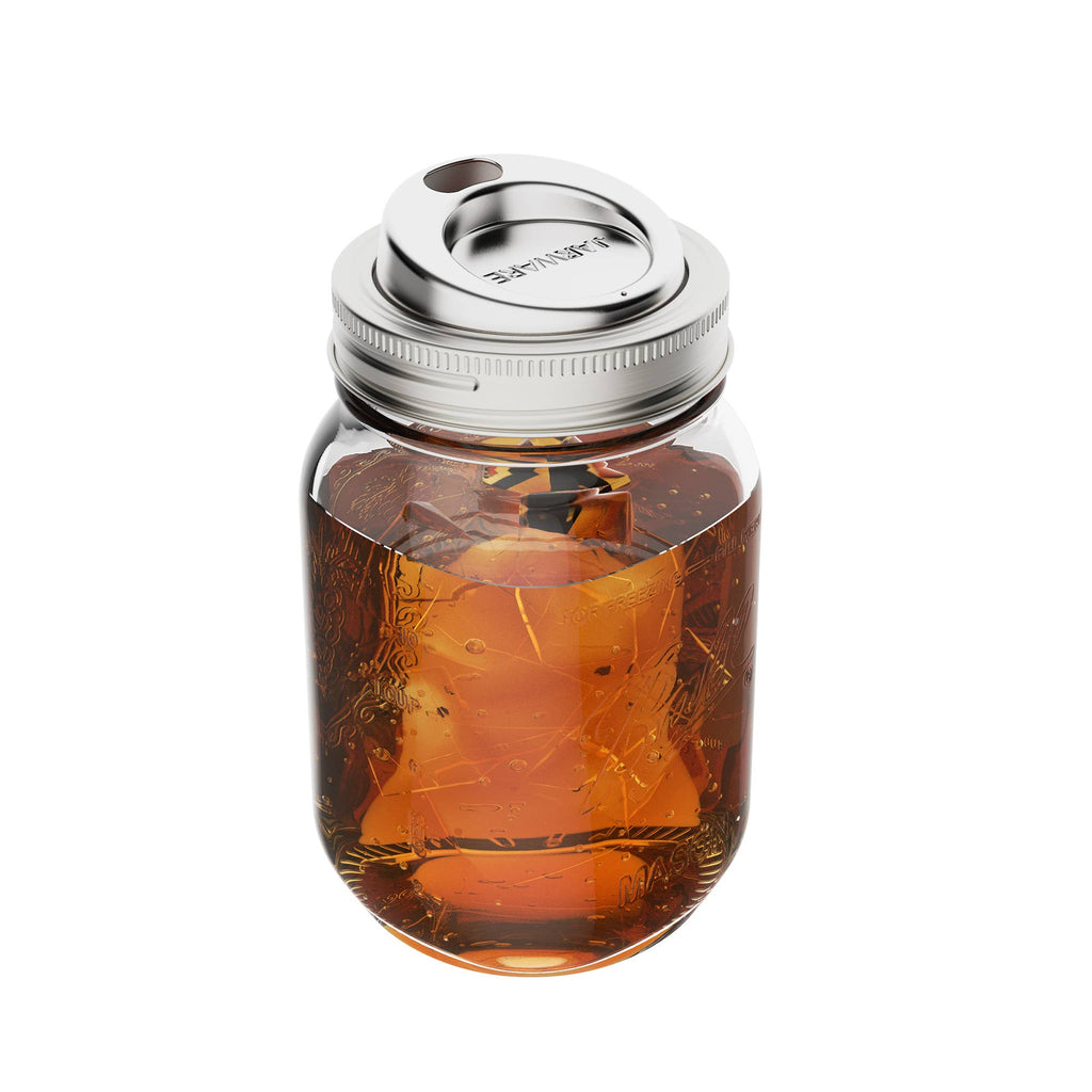 Clear glass jar with metal lid containing a dark liquid on a white background