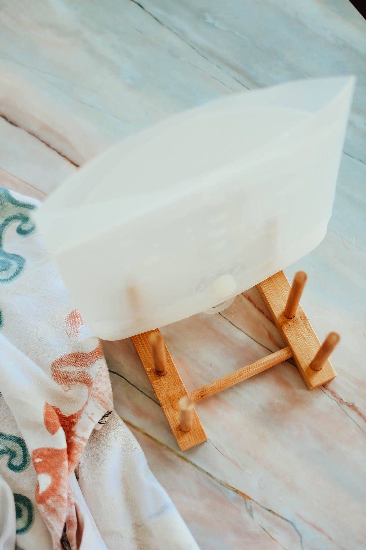 White reusable bag on a wooden stand with a blurred background