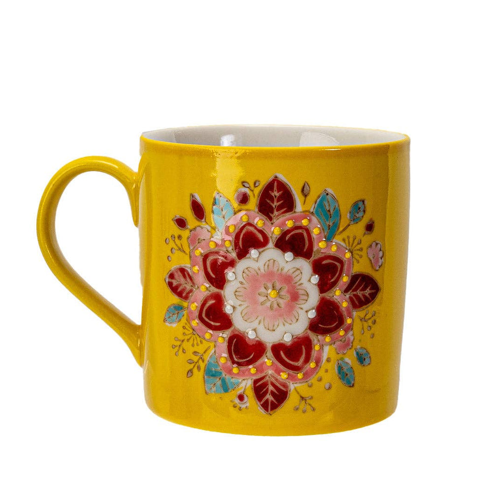 Yellow mug with a colorful floral design on a white background