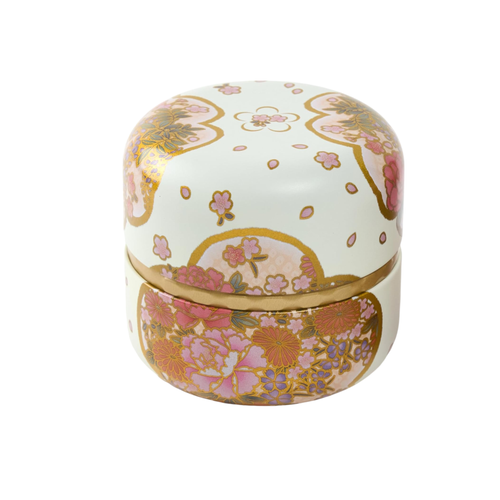 Decorative tea tin with floral patterns on a white background