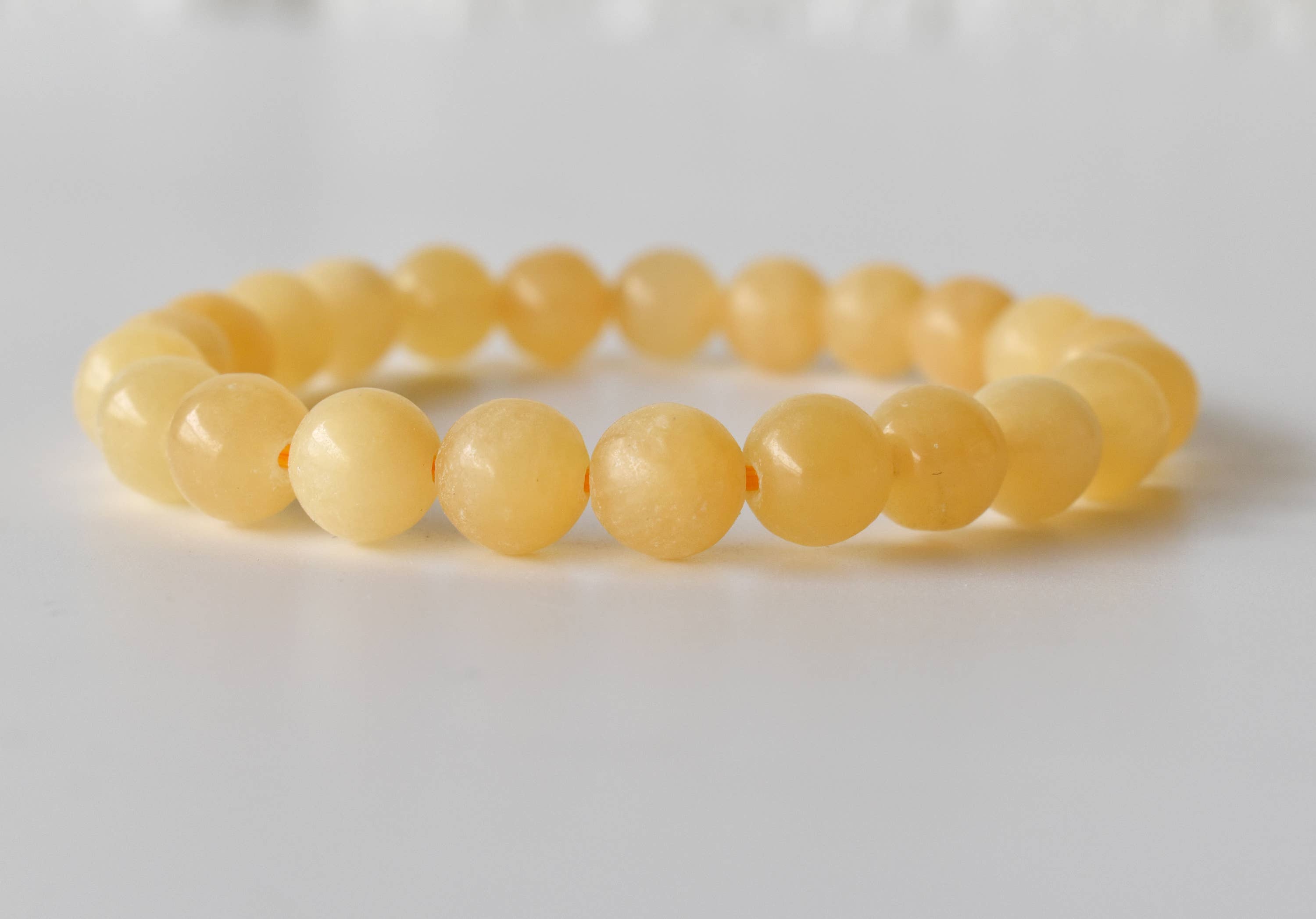 Yellow beaded bracelet on a white background