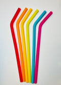 6 Silicone straws in rainbow colors with bend on a white background.
