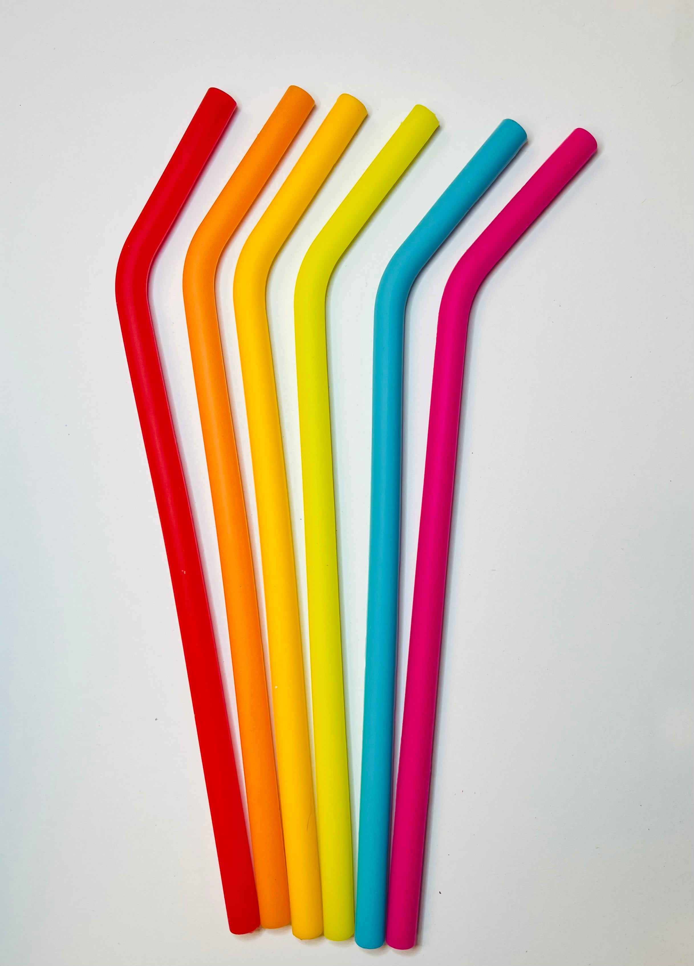 6 Silicone straws in rainbow colors with bend on a white background.