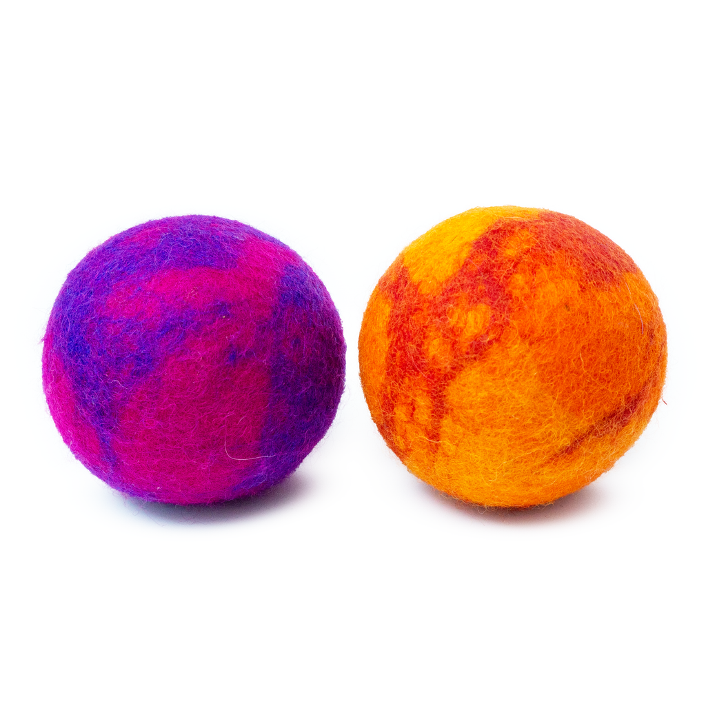 Two colorful felted balls, one purple and one orange, on a white background.