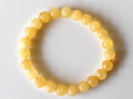 Yellow beaded bracelet on a white background