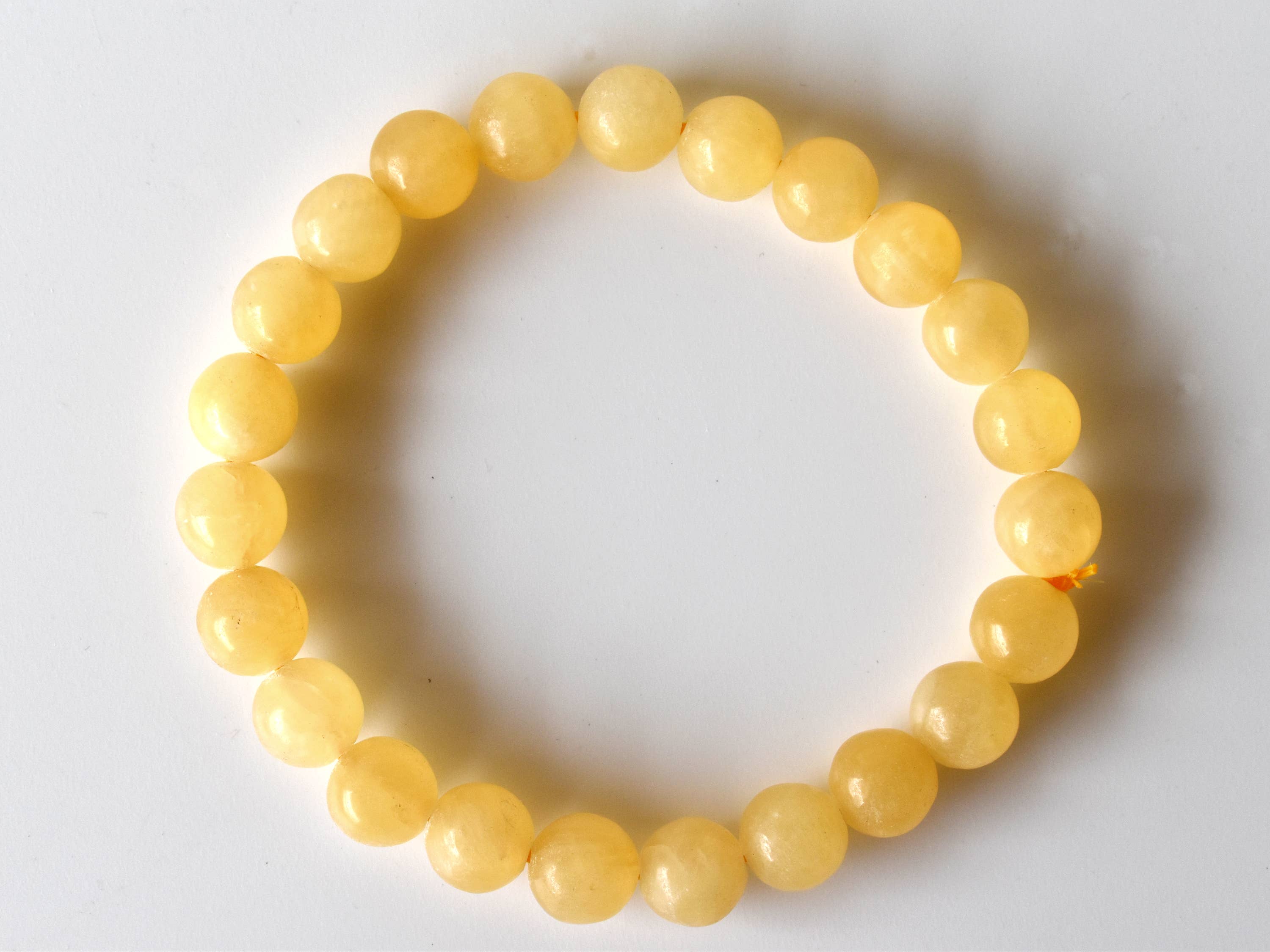 Yellow beaded bracelet on a white background