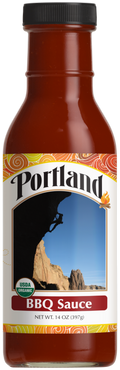 Bottle of Portland BBQ Sauce with a label featuring a rock climber and mountain.