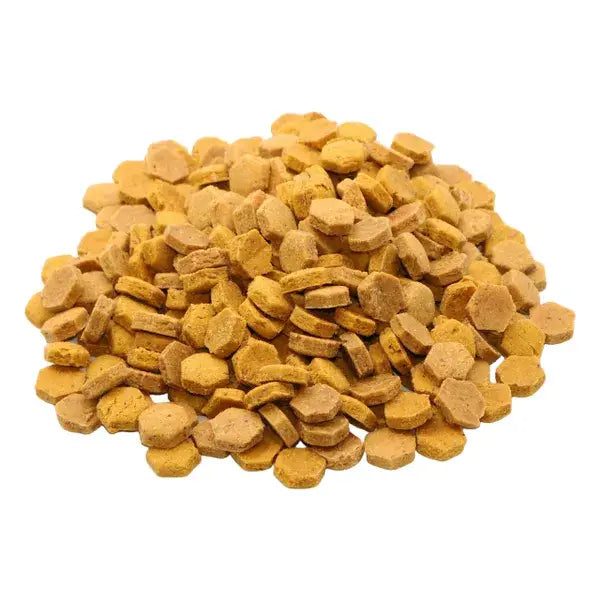 Pile of yellow dog/cat treats on a white background