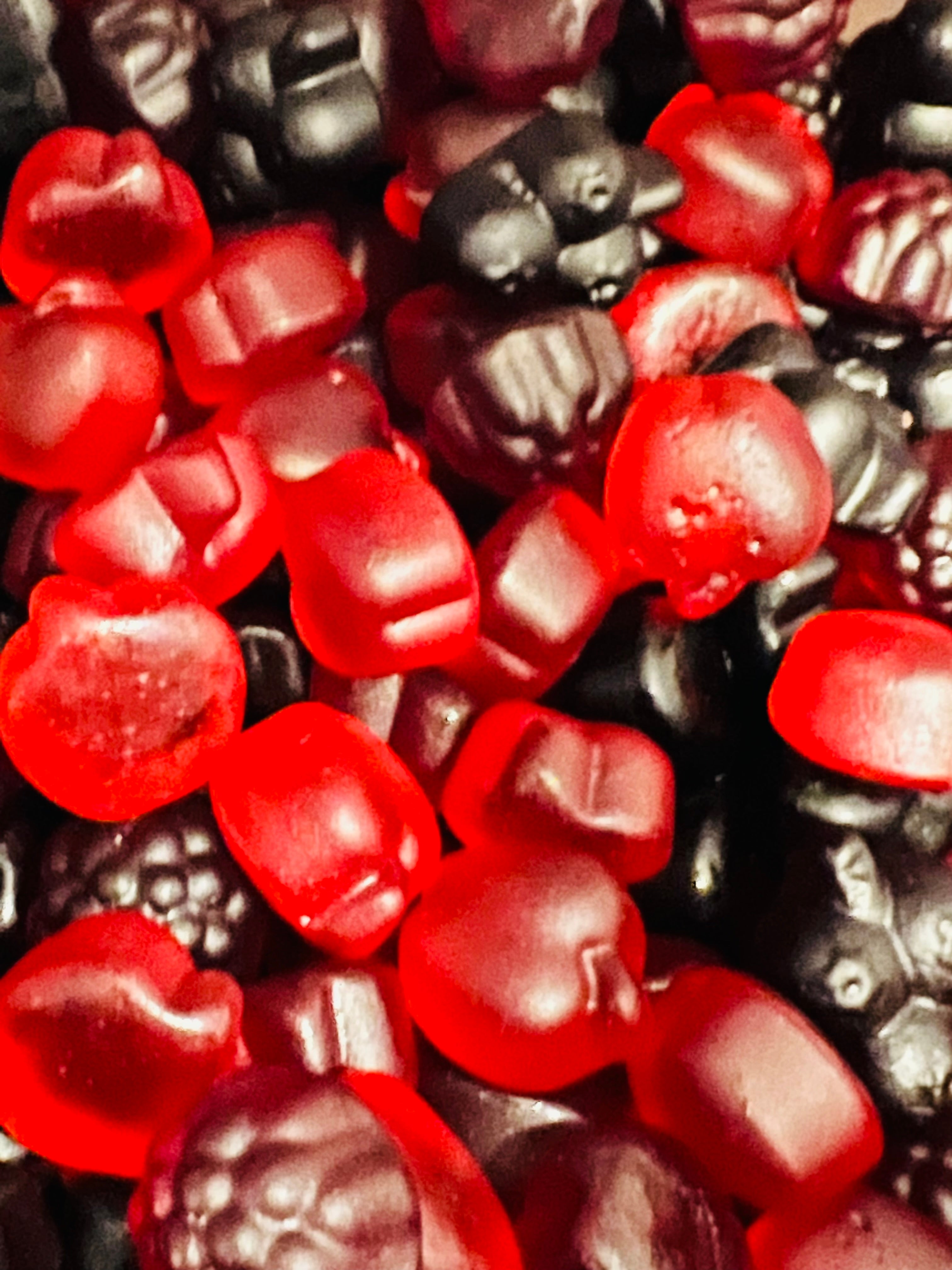 Close-up of red and black gummy fruit shapes