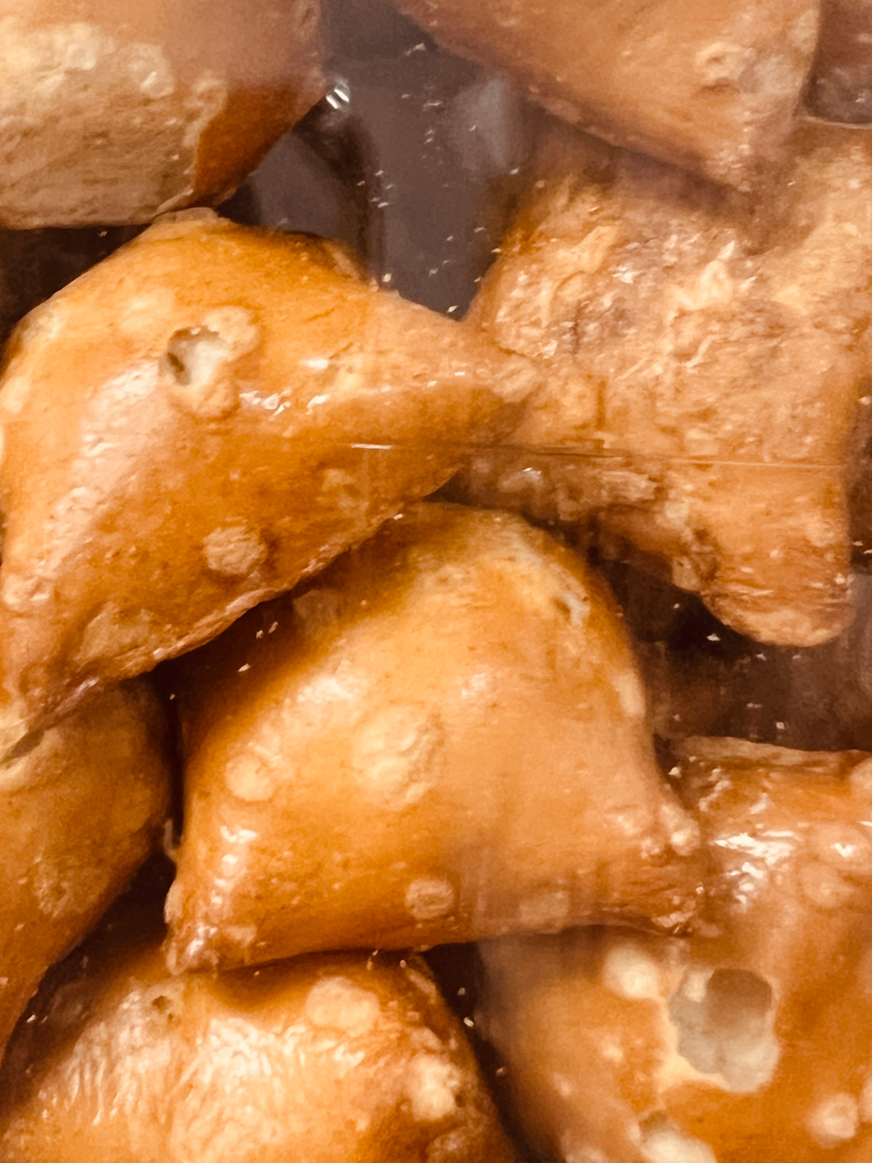 Close-up of peanut butter filled pretzel chunks, with a glossy texture.