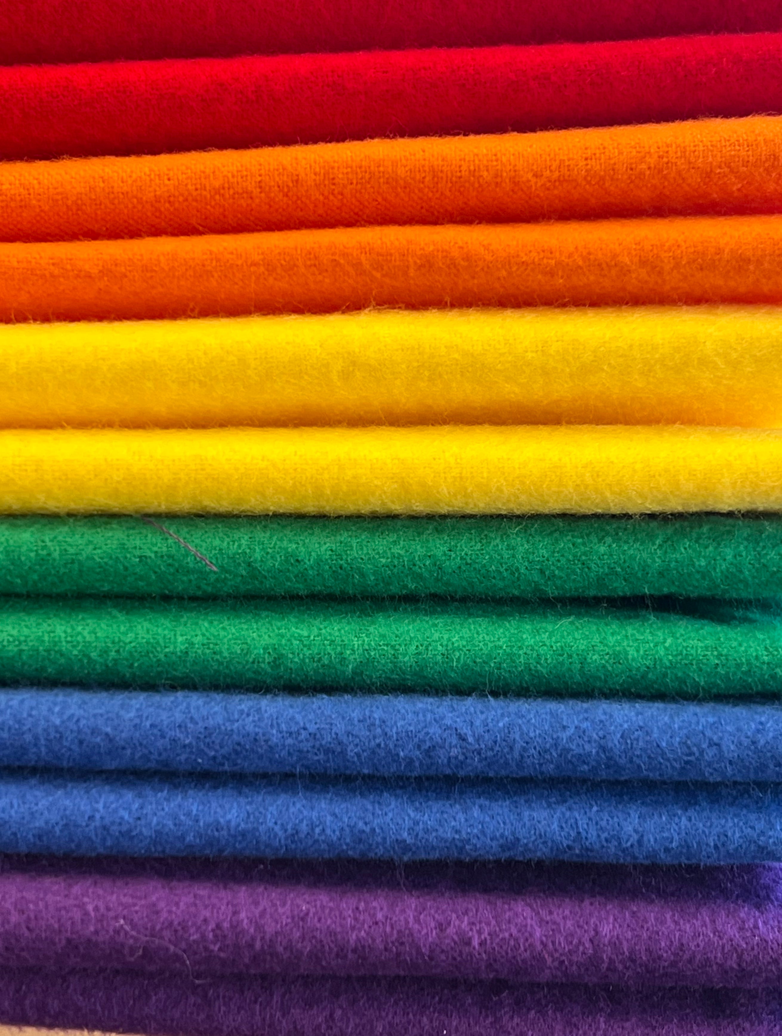 Stack of colorful fabric in a rainbow pattern