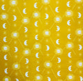 Pattern of suns, moons, and stars on a yellow background