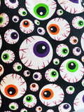Orange, Green, and Purple BloodShot Eyeball Fabric with a black background. 