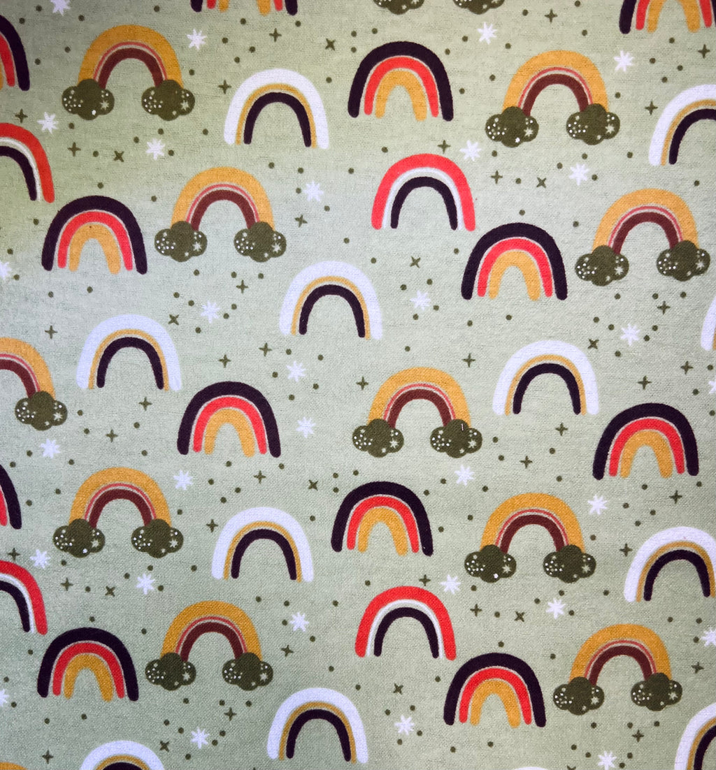Pattern of colorful rainbows and clouds on a green background
