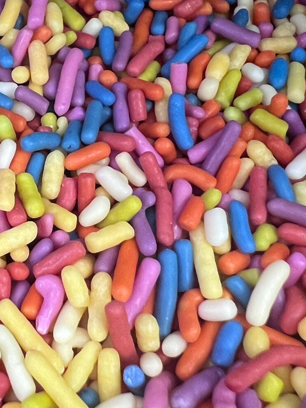 Colorful candy sprinkles in various shapes and sizes.