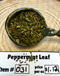 Spoon filled with peppermint leaves on a wooden surface with price label.