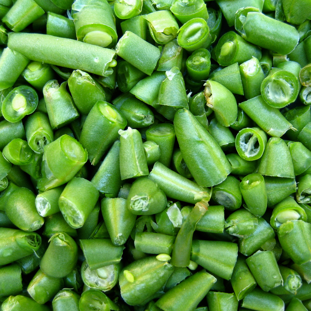 A close-up, top-down view of chopped green beans, showing their bright green color and cut ends.