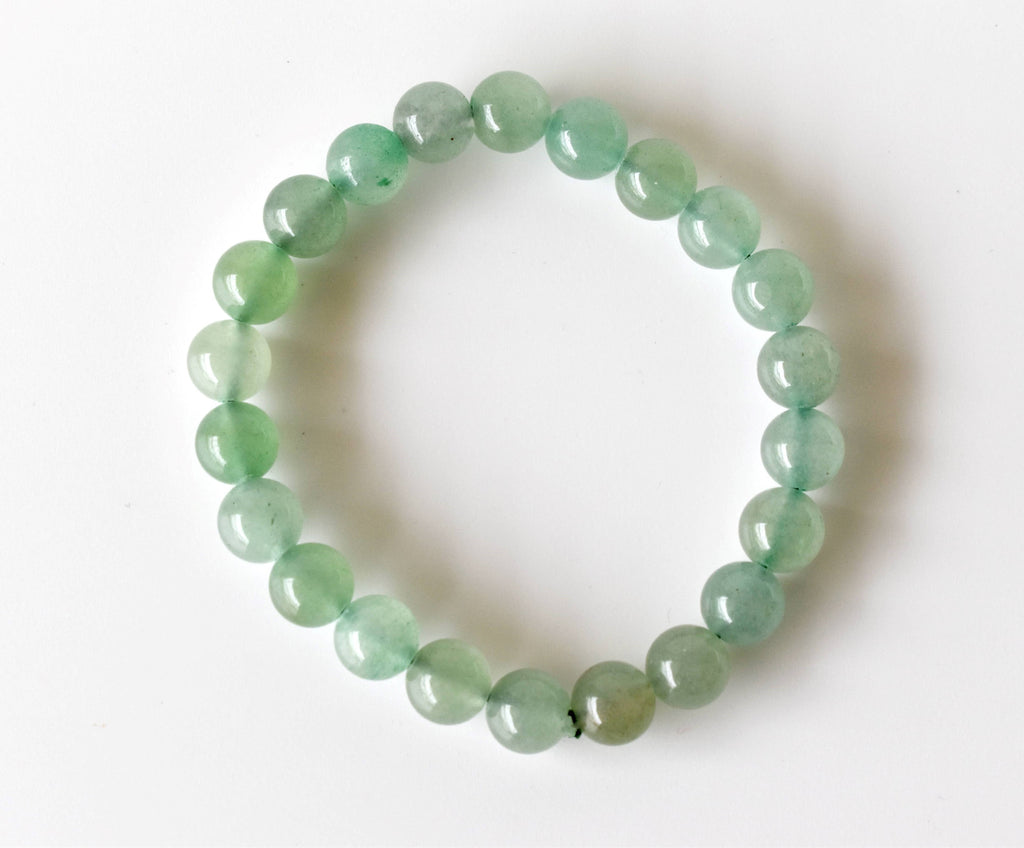 Green beaded bracelet on a white background