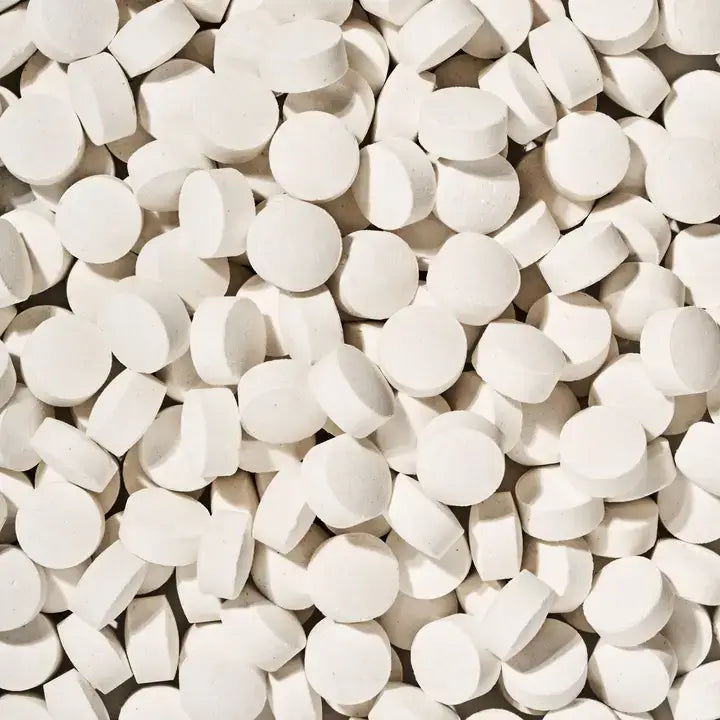 Close-up of a large number of breath mints, small white round tablets