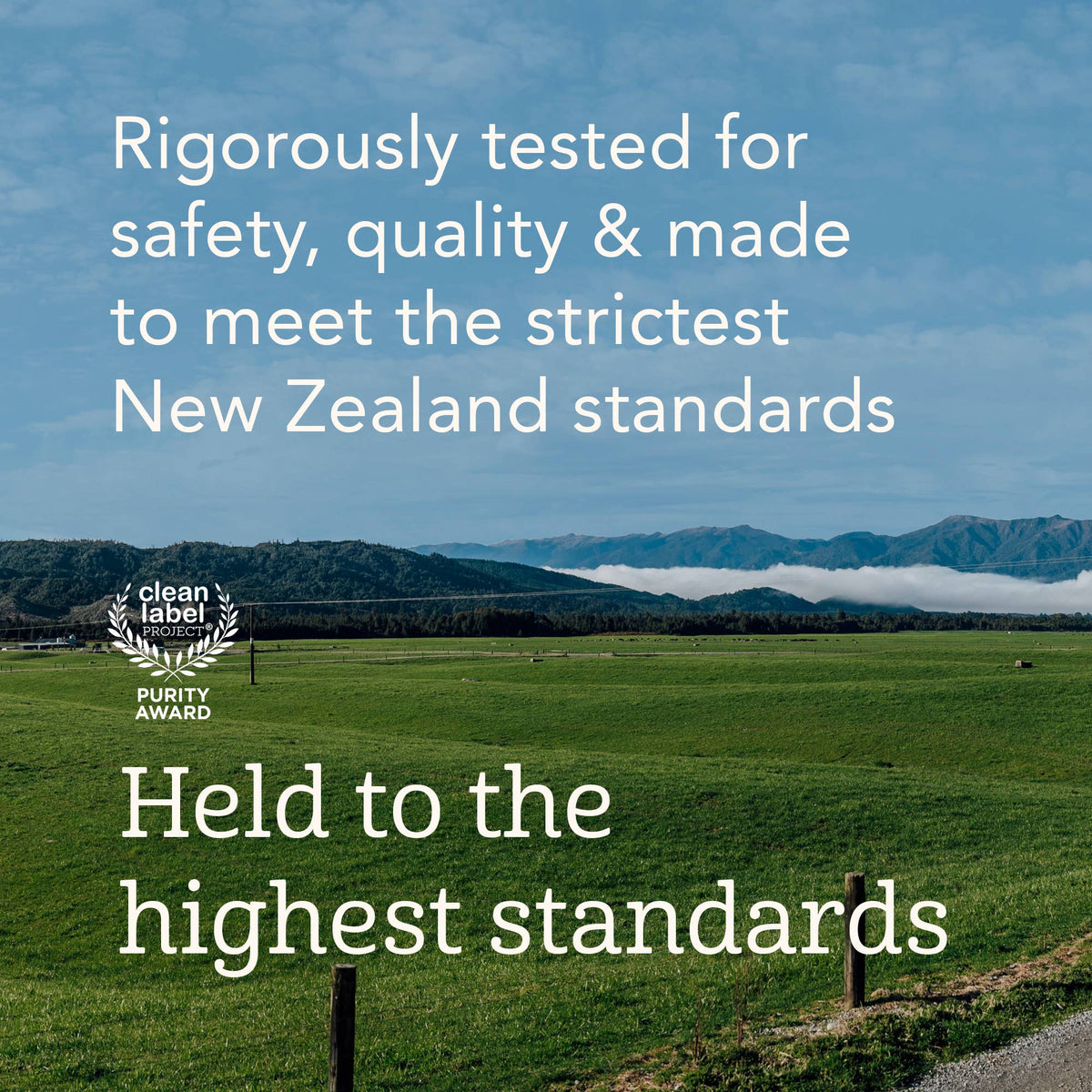A scenic landscape photo of a green field under a blue sky with mountains in the distance, overlaid with white text reading 'Rigorously tested for safety, quality & made to meet the strictest New Zealand standards' and 'Held to the highest standards,' plus a 'clean label Purity Award' emblem.