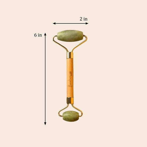 Facial roller with dimensions labeled on a beige background